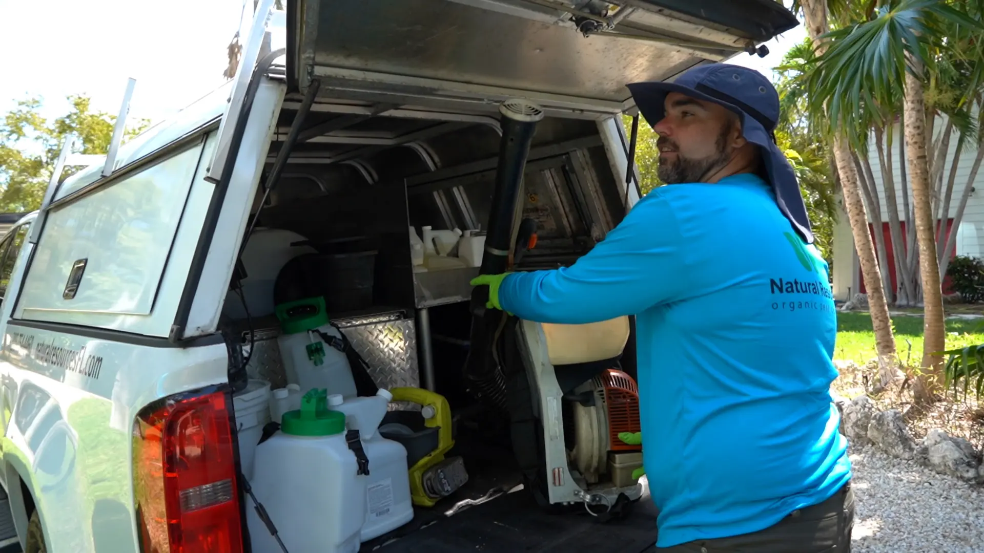 Natural Resources technician loading eco friendly equipment from the service truck